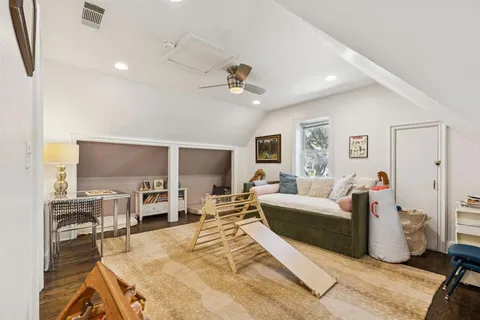 a living room with furniture a flat screen tv and kitchen view