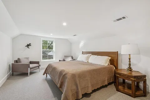 a bedroom with a bed and a couch