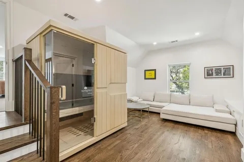 a living room with furniture and a wooden floor