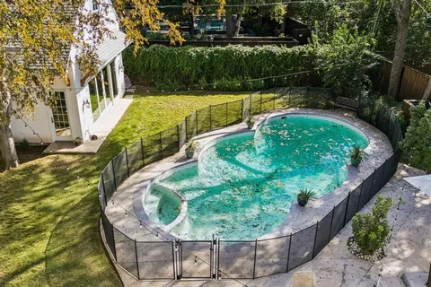 a view of a swimming pool with a yard