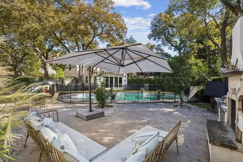 a patio with a table and chairs under an umbrella