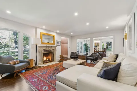 a living room with furniture fireplace and window