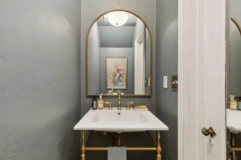 a bathroom with a sink a mirror and a window