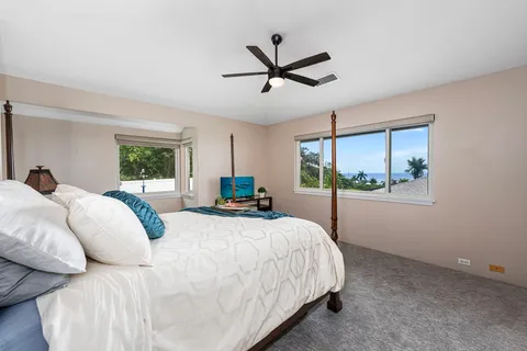 a bed room with a bed and a large window