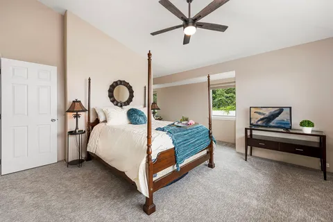 a bed room with a bed and a chandelier