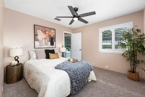 a bedroom with a bed and a potted plant