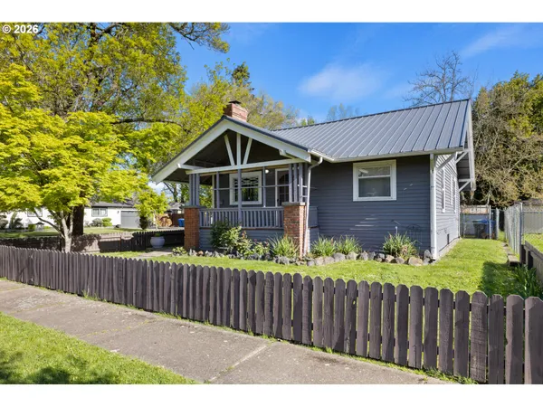 a front view of a house with wooden fence