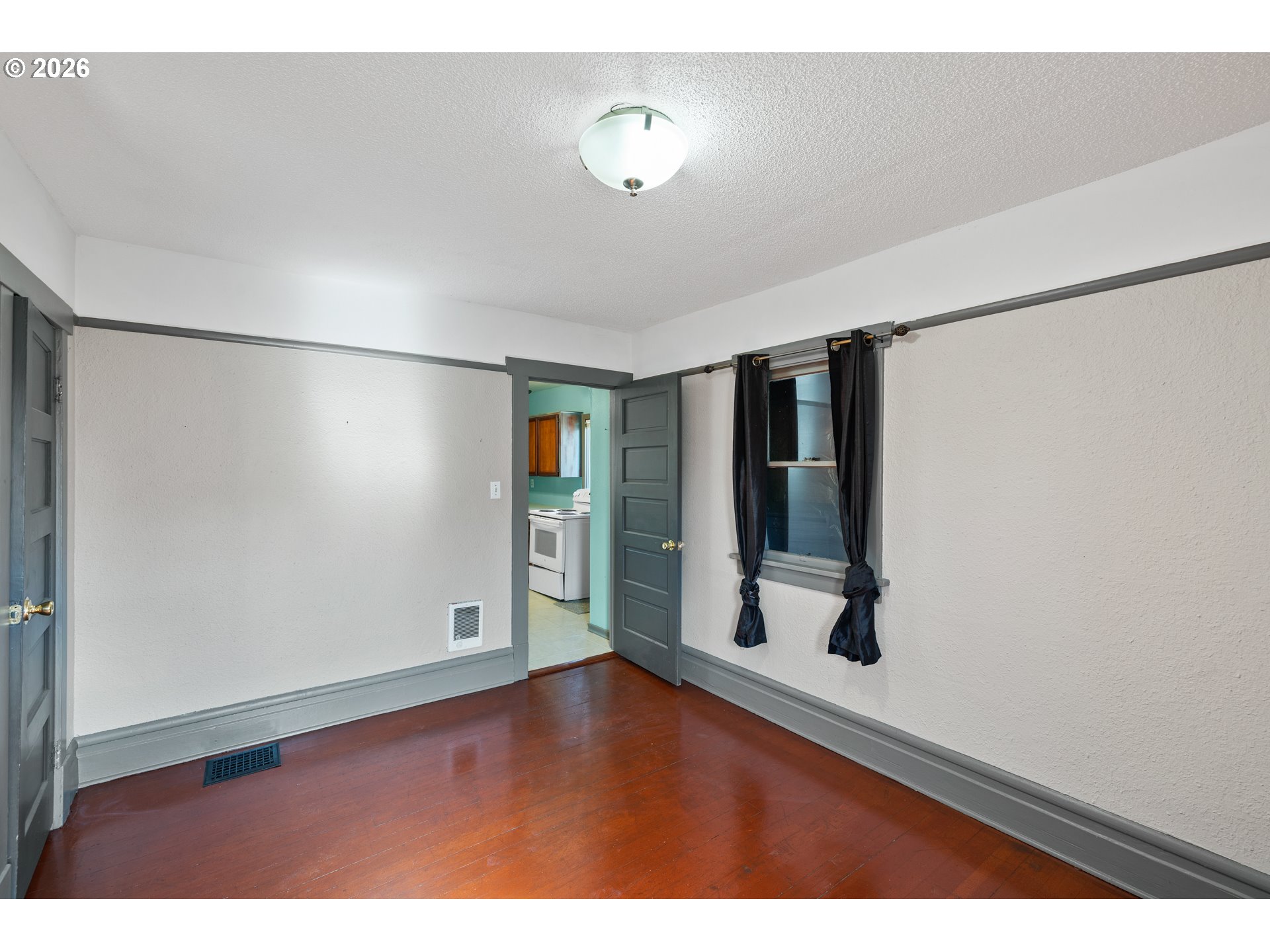 1115 Shipping Street Northeast Salem, OR 97301 - Photo 17 of 24 a view of an empty room with wooden floor and a window
