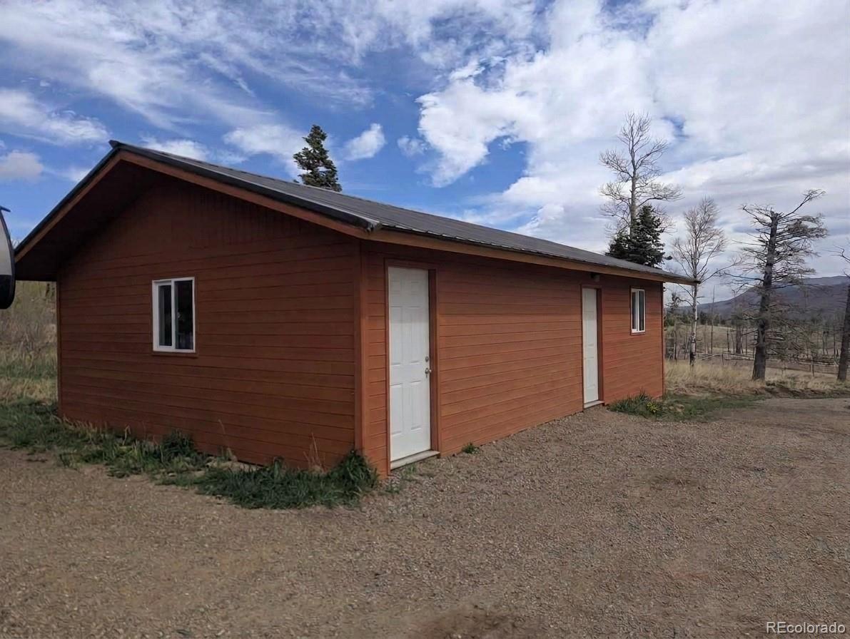 2084 Forbes Park Road Fort Garland, CO 81133 - Photo 6 of 39 a front view of a house with a garage