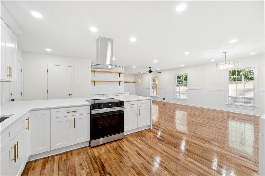 2055 Oak Road Southwest Snellville, GA 30078 - Photo 14 of 33 a large kitchen with stainless steel appliances granite countertop a stove and a sink