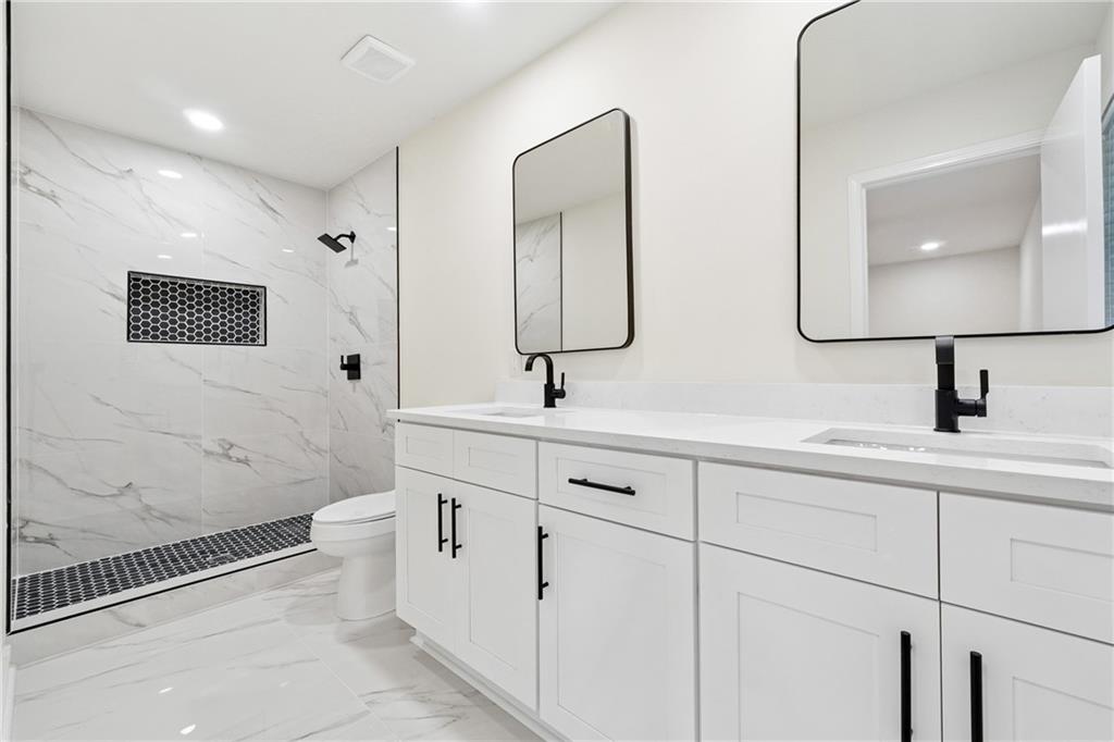 2055 Oak Road Southwest Snellville, GA 30078 - Photo 16 of 33 a bathroom with a toilet sink and mirror