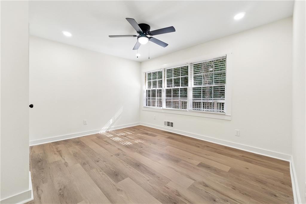 2055 Oak Road Southwest Snellville, GA 30078 - Photo 19 of 33 a view of an empty room with a window and a ceiling fan