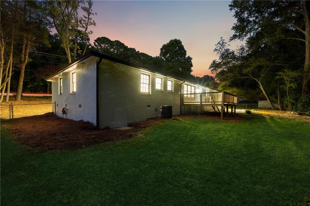 2055 Oak Road Southwest Snellville, GA 30078 - Photo 33 of 33 a view of backyard with table and chairs potted plants and large tree