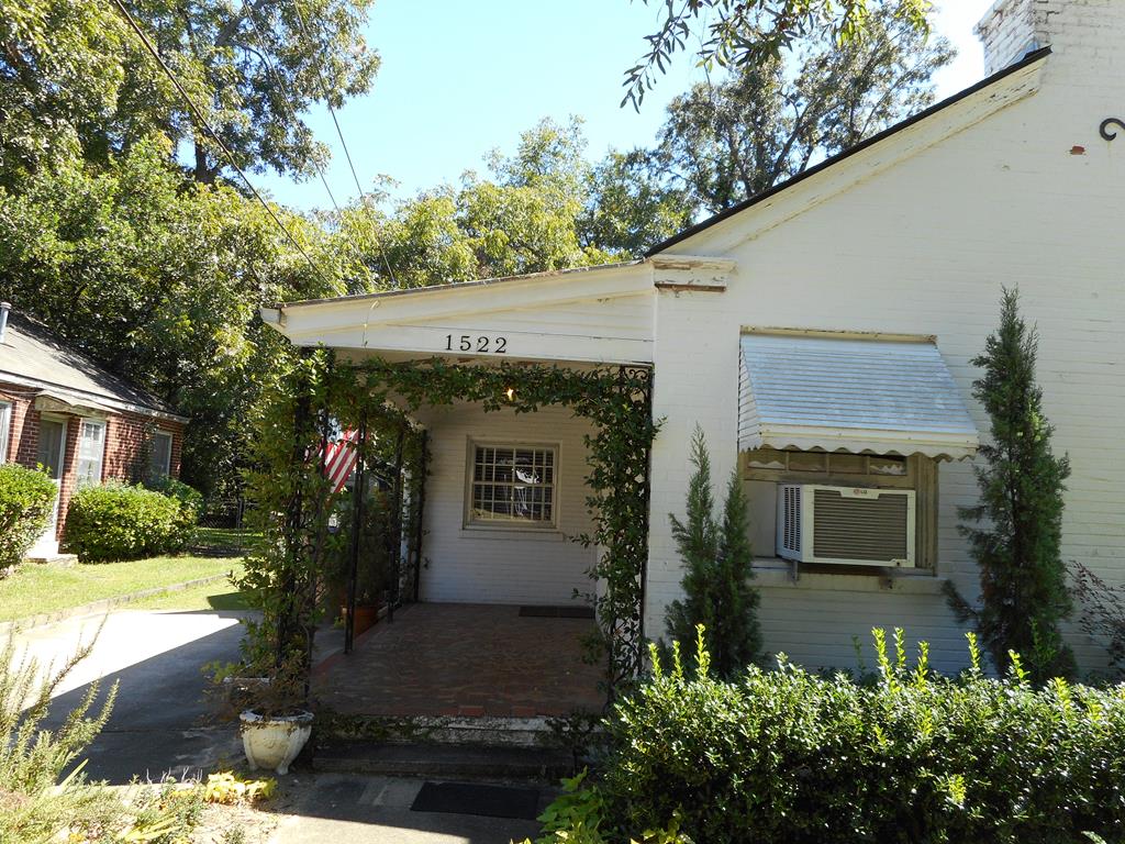 1522 30th Street Columbus, GA 31904 - Photo 1 of 4 a front view of a house with garden