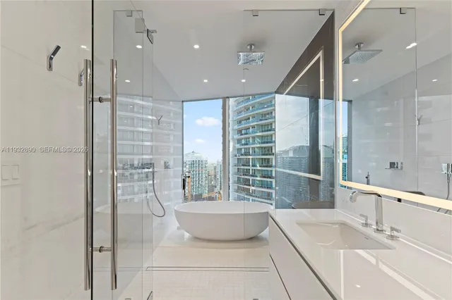 a spacious bathroom with a large tub shower and checkered floor