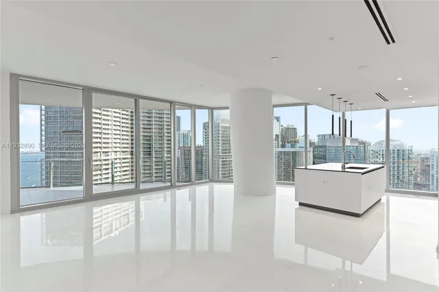 a view of an empty room with a floor to ceiling window and an outdoor kitchen