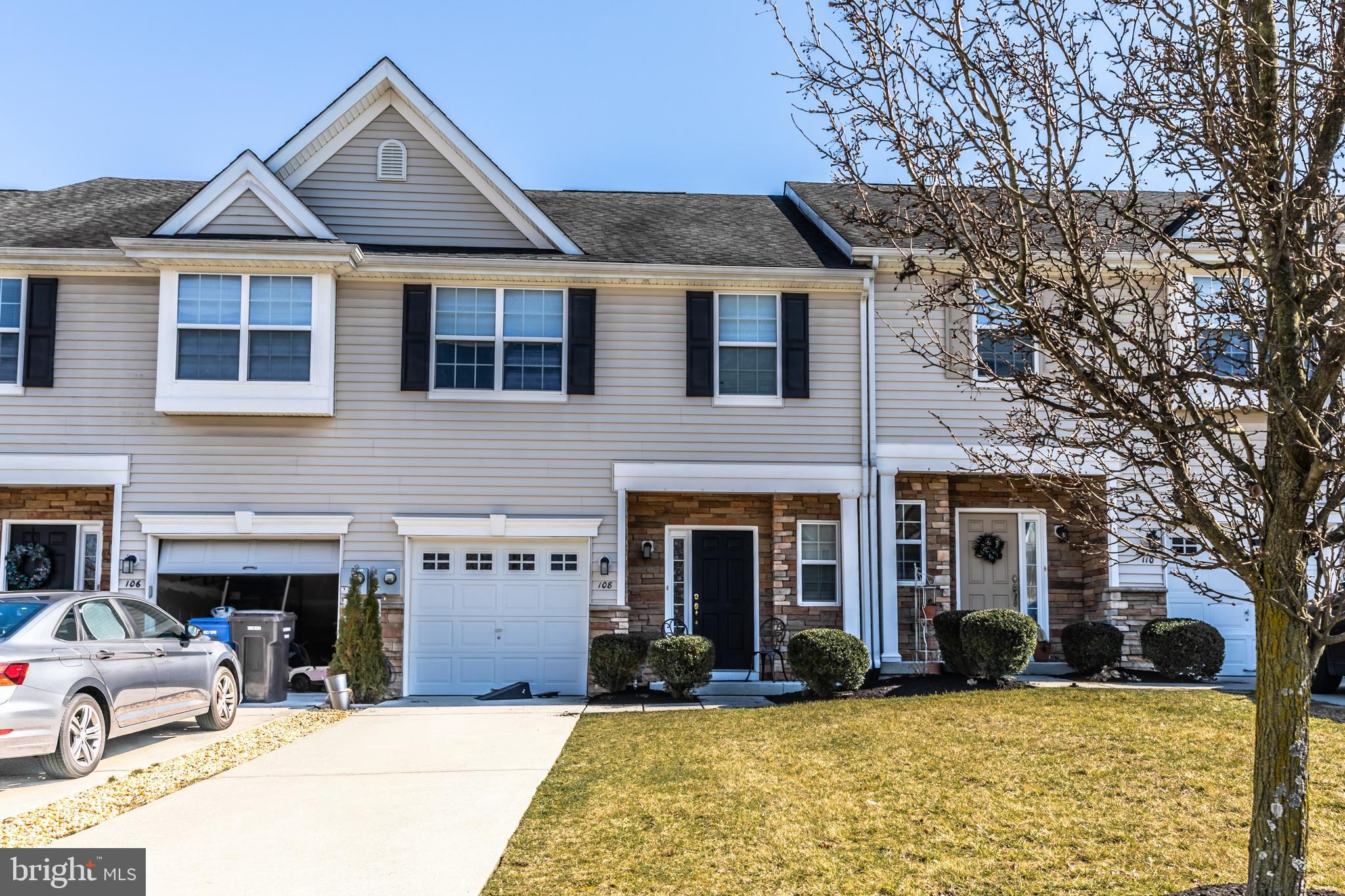 a view of a building with a large tree in front of house