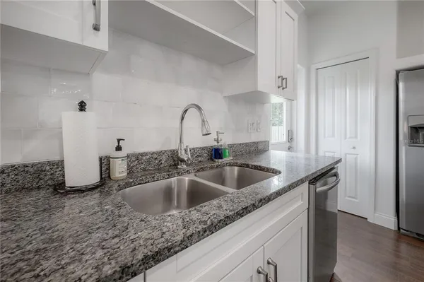 a kitchen with a sink and a refrigerator