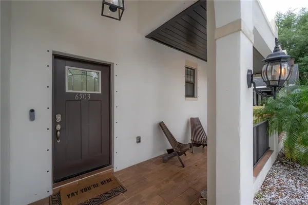 a view of a hallway with workspace and living room