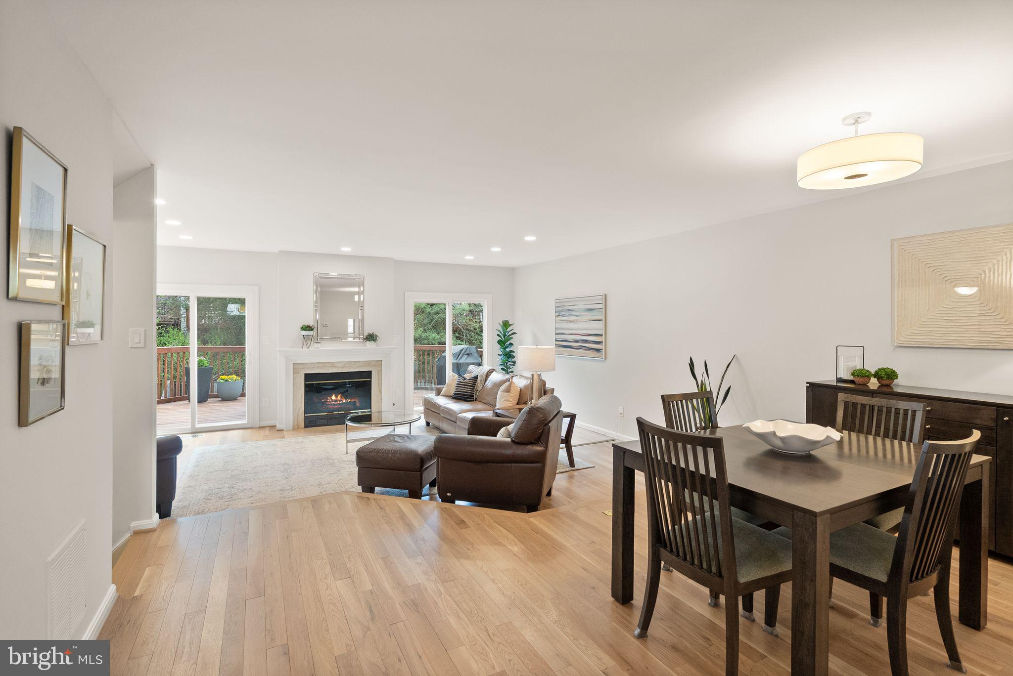 6369 English Ivy Way Springfield, VA 22152 - Photo 10 of 62 a living room with furniture a fireplace and a dining table with wooden floor