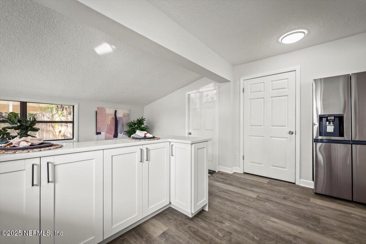 2905 Sandhurst Road East Jacksonville, FL 32277 - Photo 15 of 28 a kitchen with white cabinets and stainless steel appliances