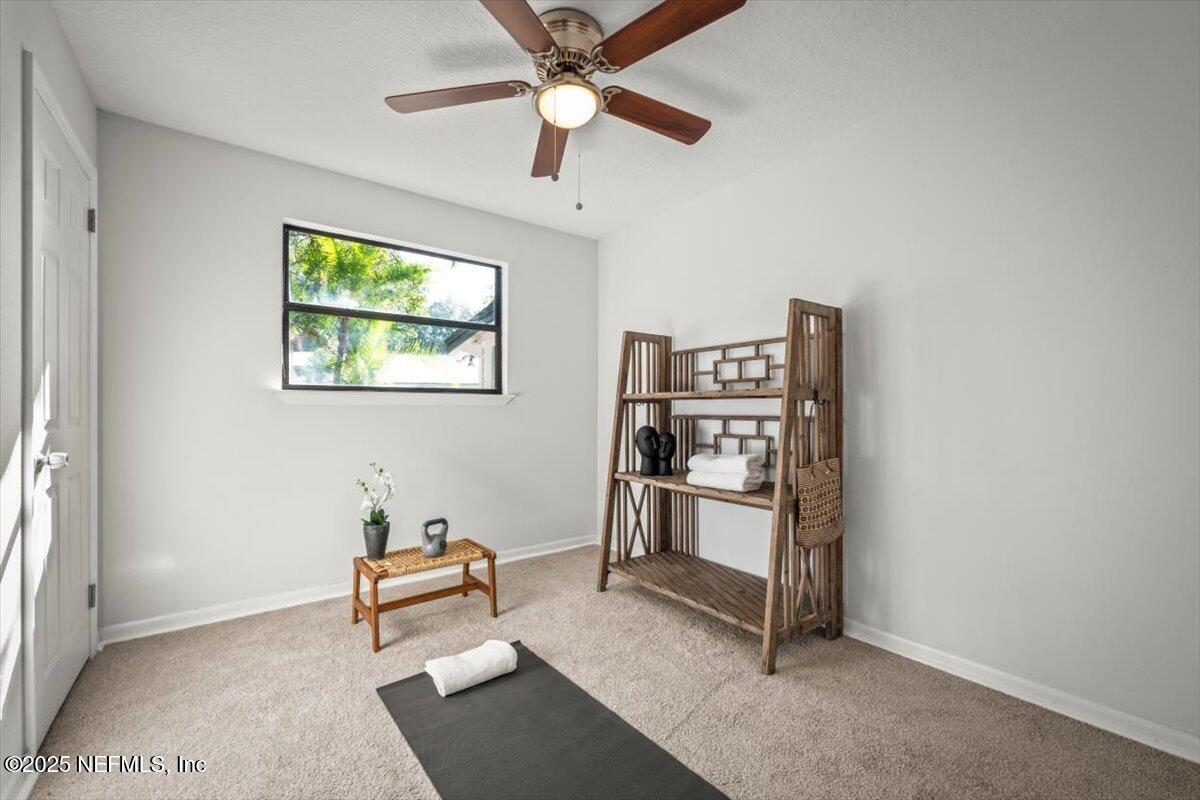2905 Sandhurst Road East Jacksonville, FL 32277 - Photo 20 of 28 a living room with furniture a window and a ceiling fan