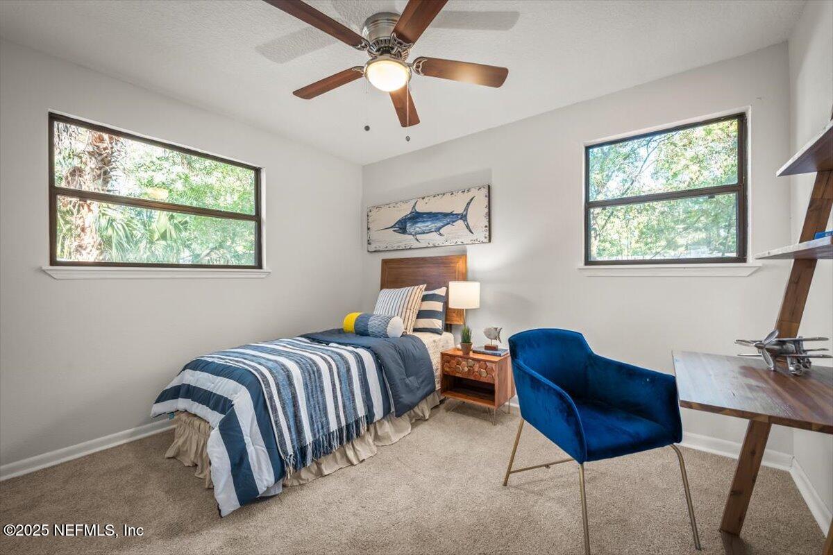 2905 Sandhurst Road East Jacksonville, FL 32277 - Photo 24 of 28 a bedroom with furniture and a window