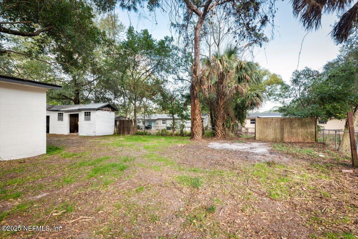 2905 Sandhurst Road East Jacksonville, FL 32277 - Photo 27 of 28 a view of a yard in front of a house with large trees