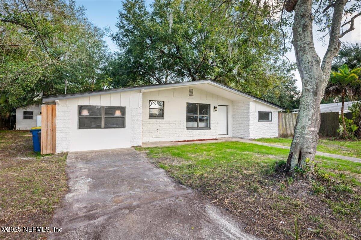 2905 Sandhurst Road East Jacksonville, FL 32277 - Photo 3 of 28 a view of a house with backyard and trees