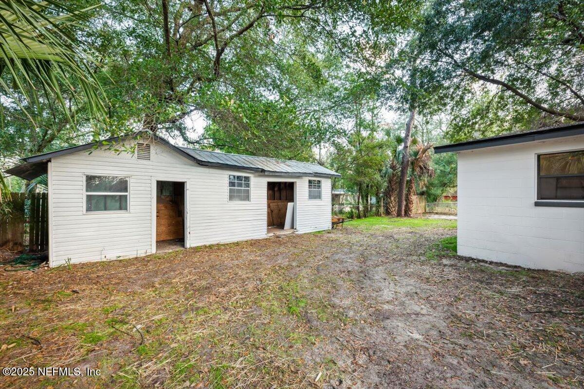 2905 Sandhurst Road East Jacksonville, FL 32277 - Photo 4 of 28 a view of a house with a yard and large tree