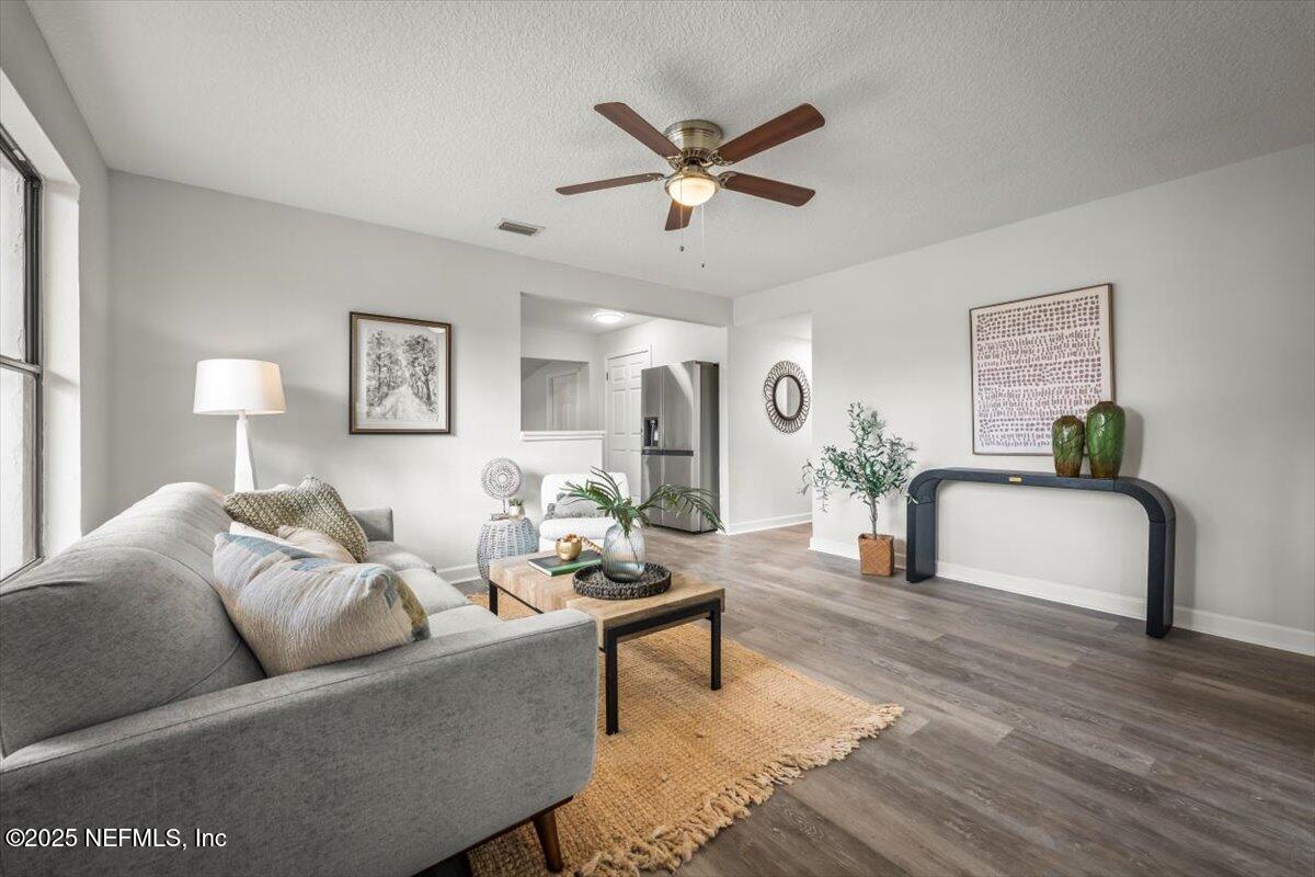 2905 Sandhurst Road East Jacksonville, FL 32277 - Photo 6 of 28 a living room with furniture and a wooden floor