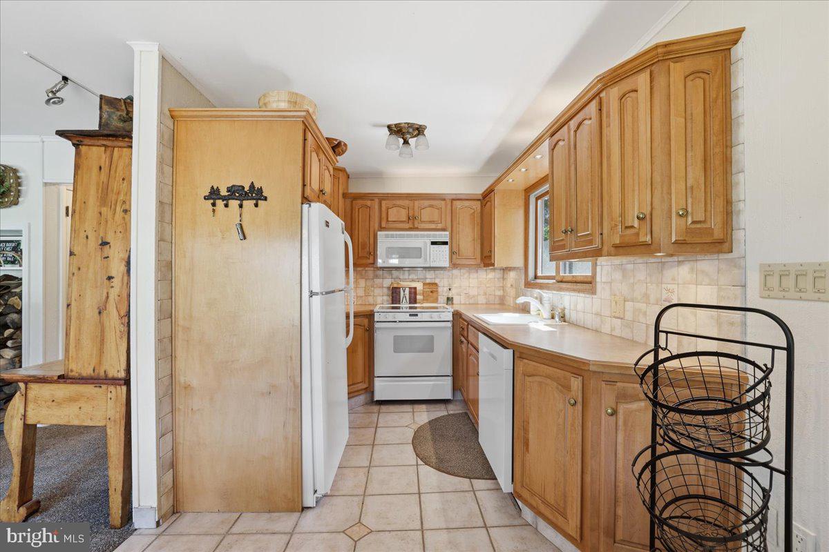 25 Fall Place Union Dale, PA 18470 - Photo 23 of 99 a kitchen with a refrigerator and a sink
