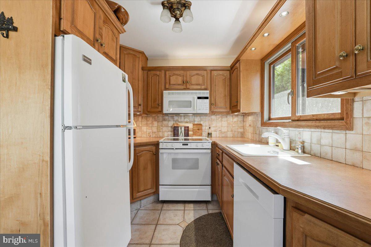 25 Fall Place Union Dale, PA 18470 - Photo 26 of 99 a kitchen with a sink cabinets and refrigerator