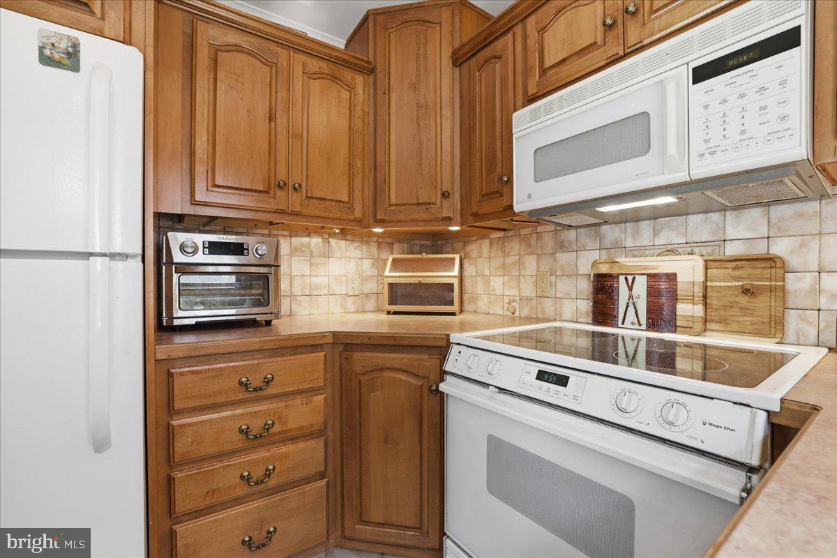 25 Fall Place Union Dale, PA 18470 - Photo 27 of 99 a kitchen with stainless steel appliances a stove and a refrigerator