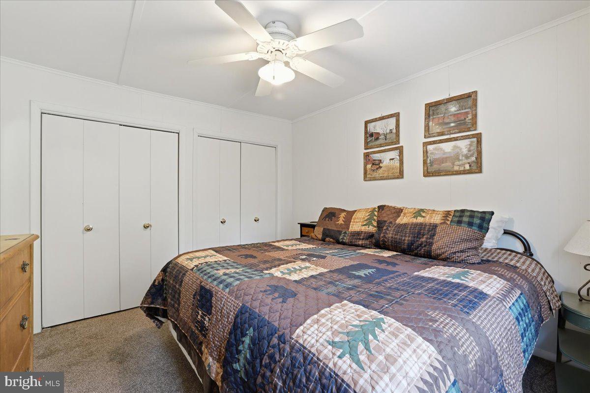 25 Fall Place Union Dale, PA 18470 - Photo 33 of 99 a bedroom with a large bed and a ceiling fan