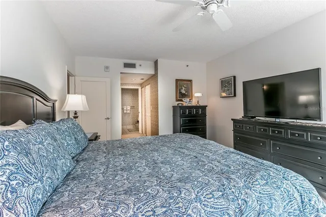 a living room with furniture a flat screen tv and a chandelier