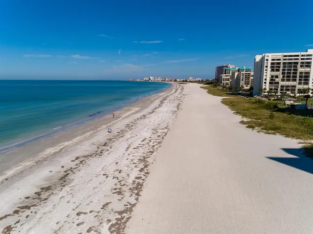 a view of a swimming pool with outdoor seating