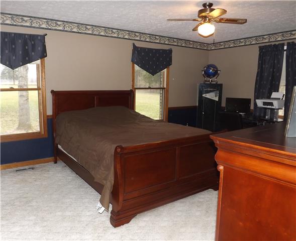173 Urban Farms Road Manchester, TN 37355 - Photo 12 of 20 a bed sitting in a bedroom next to a window