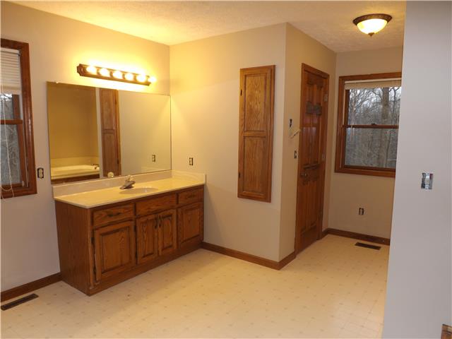 173 Urban Farms Road Manchester, TN 37355 - Photo 13 of 20 a bathroom with a double vanity sink a mirror and a shower