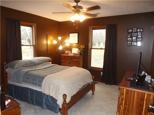 173 Urban Farms Road Manchester, TN 37355 - Photo 16 of 20 a bedroom with a bed and a chandelier
