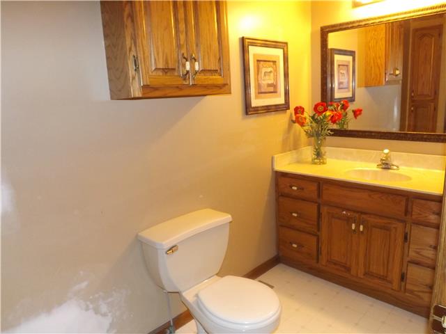 173 Urban Farms Road Manchester, TN 37355 - Photo 18 of 20 a bathroom with a toilet a sink a mirror and a window
