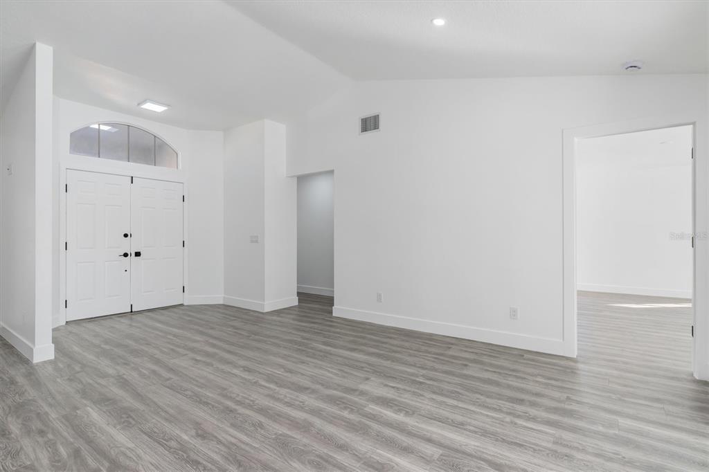 375 Waterside Street Port Charlotte, FL 33954 - Photo 11 of 49 a view of an empty room with wooden floor