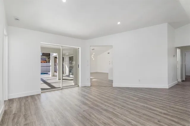 a view of empty room with wooden floor