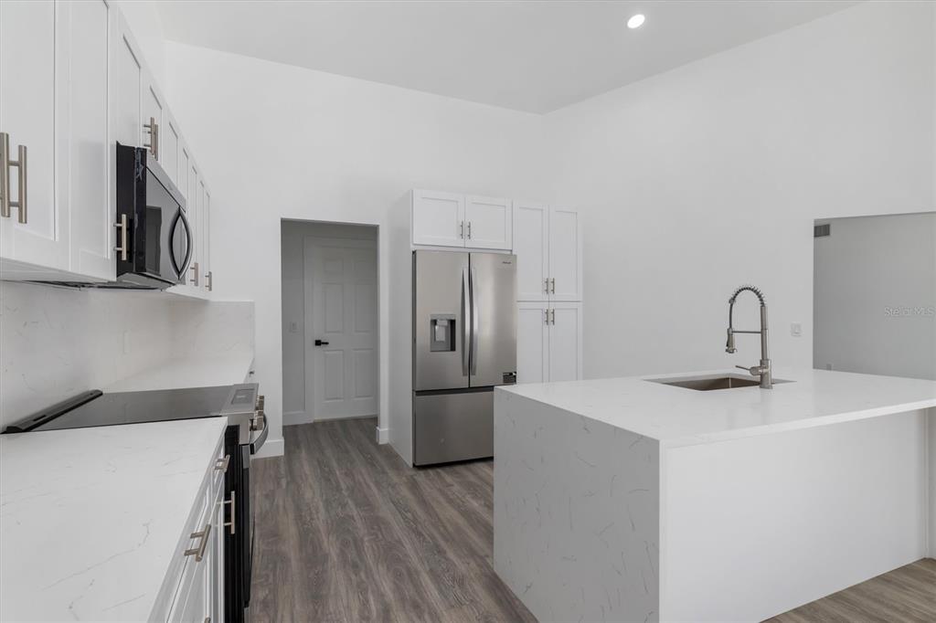 375 Waterside Street Port Charlotte, FL 33954 - Photo 17 of 49 a kitchen with a sink and wooden floor