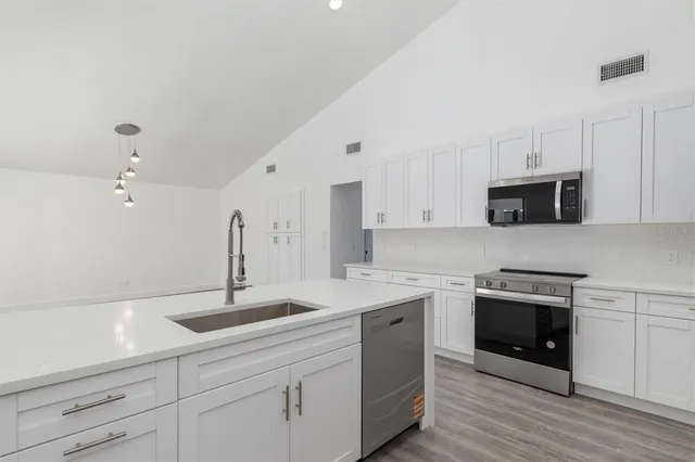 a kitchen with a sink and cabinets
