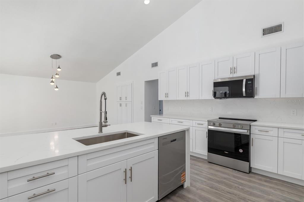 375 Waterside Street Port Charlotte, FL 33954 - Photo 18 of 49 a kitchen with a sink and cabinets