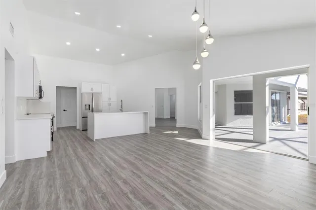 a view of a kitchen with wooden floor and a kitchen