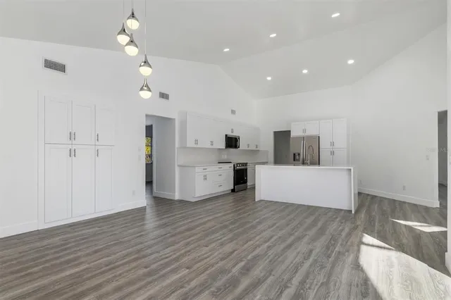 a view of a kitchen with microwave and cabinets
