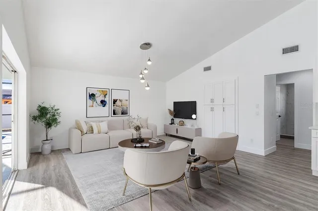a living room with furniture a rug and a flat screen tv
