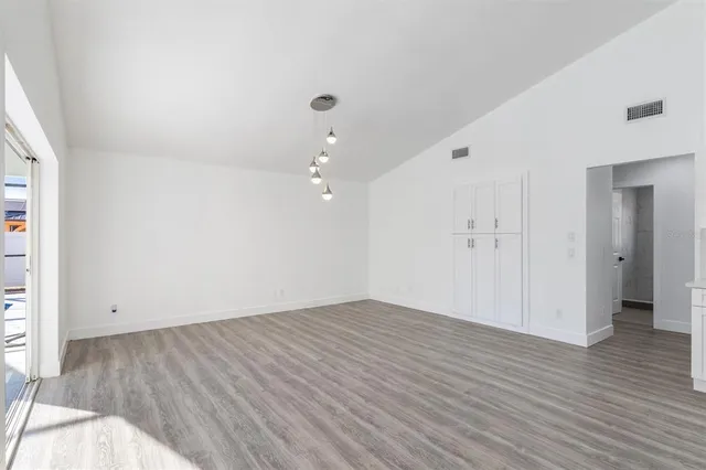 an empty room with wooden floor